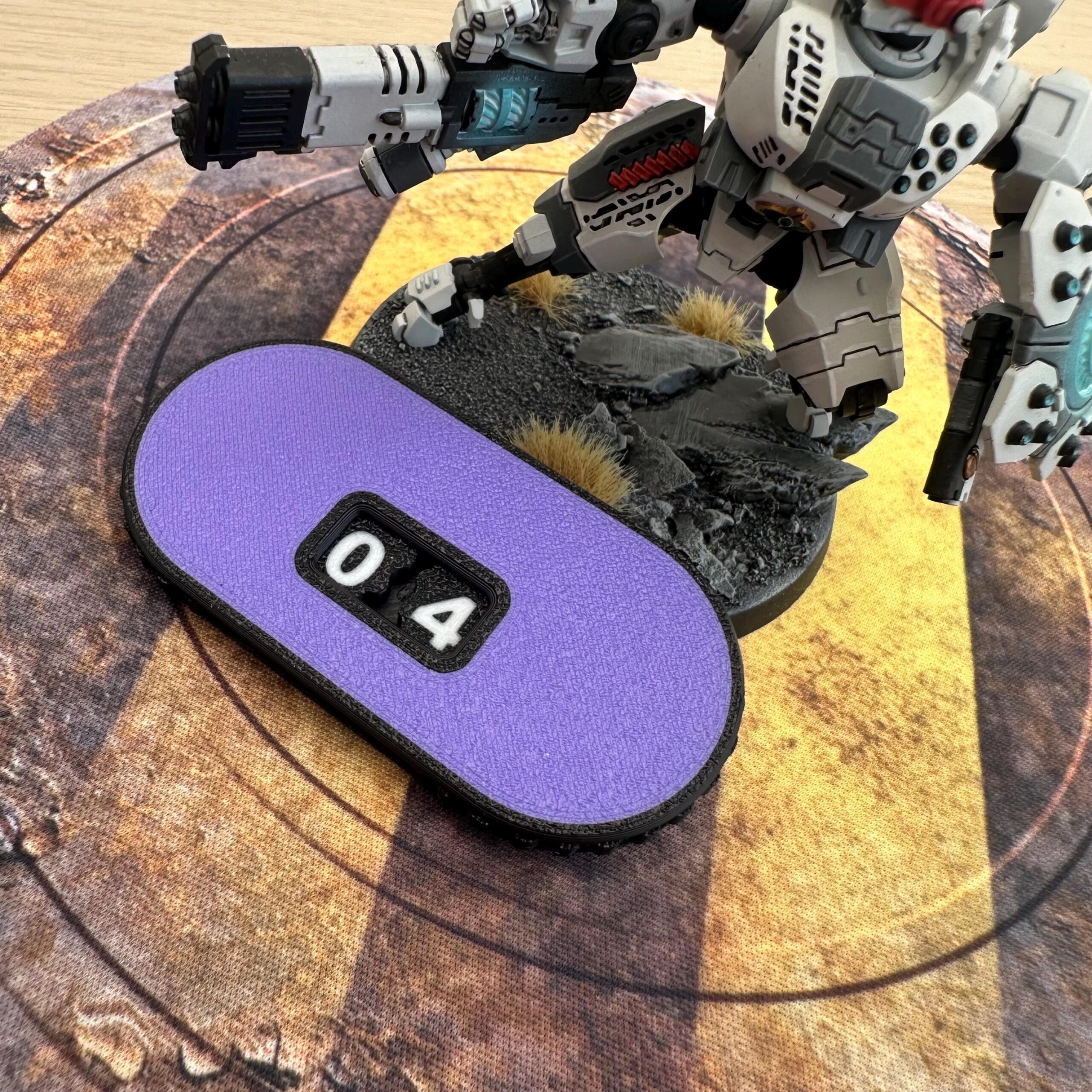 An oval-shaped purple counter with a black border featuring two white mechanical digits displaying the number 04.