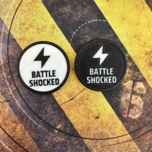 Two circular patches featuring a lightning bolt icon above the text BATTLE SHOCKED.